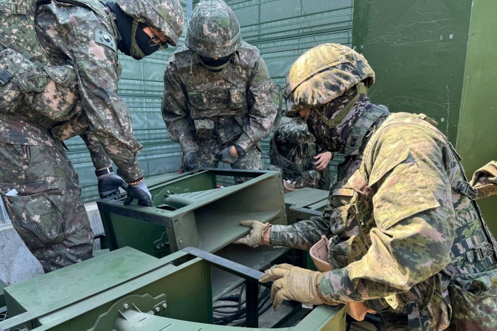South Korean soldiers work on a loudspeaker set up for propaganda broadcasts during a military drill near the Demilitarised Zone. Photo: Handout via Reuters