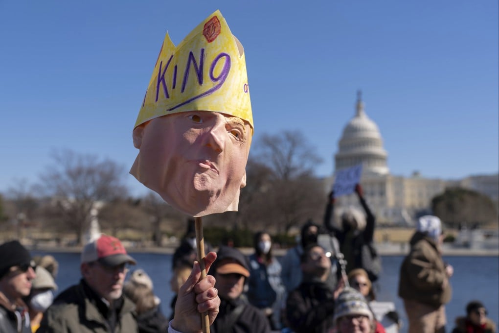 FILE - People take part in the “No Kings Day” protest on Presidents Day in Washington, in support of federal workers and against recent actions by President Donald Trump and Elon Musk, Monday, Feb. 17, 2025, by the Capitol in Washington. (AP Photo/Jose Luis Magana,File)