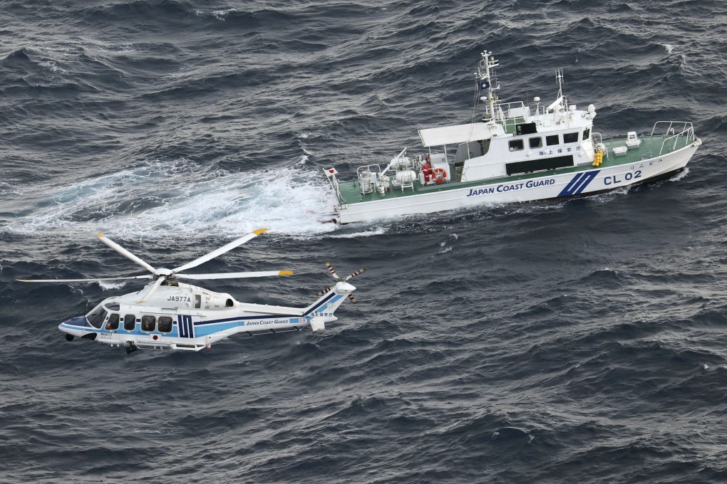 A Japan coastguard patrol ship and helicopter during an operation in southwestern Japan. Photo: Kyodo