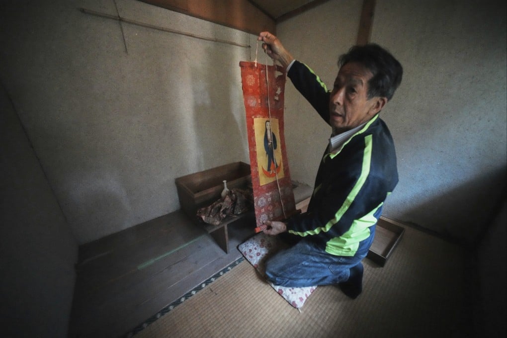 Masatsugu Tanimoto, a Hidden Christian on Ikitsuki Island, in Japan’s Nagasaki prefecture, holds a scroll featuring a disguised version of Virgin Mary and Jesus. He is one of a shrinking number of practitioners continuing to uphold centuries-old traditions. Photo: AP