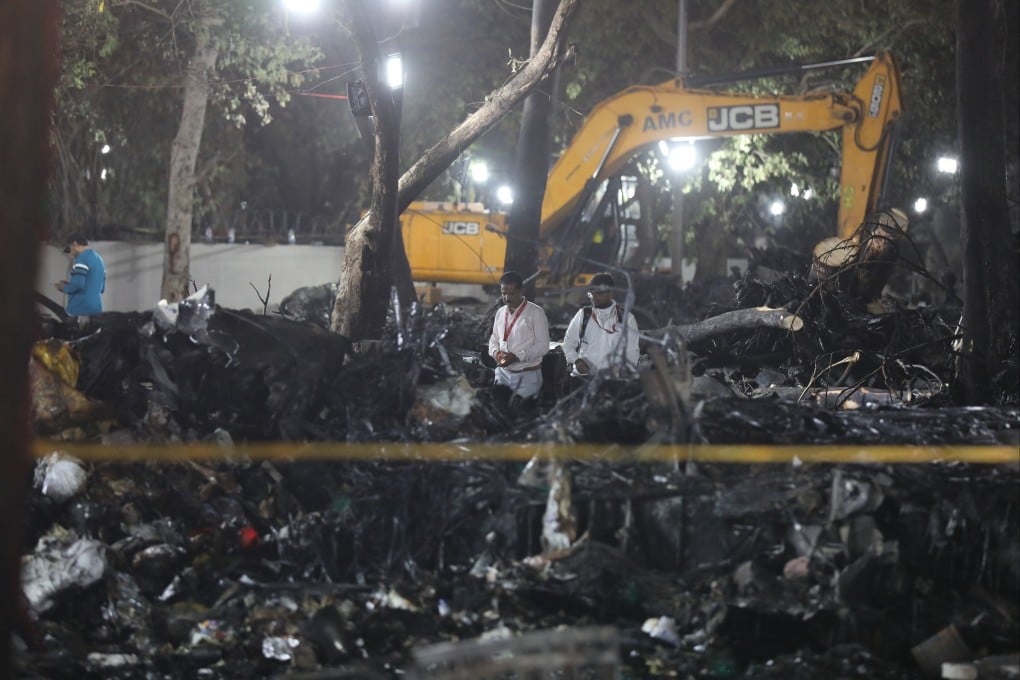 Officials inspect the site of a Boeing plane crash near Sardar Vallabhbhai Patel International Airport in Ahmedabad, Gujarat, western India on Thursday. Photo: EPA-EFE