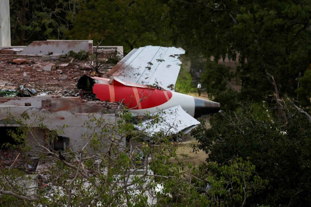 A tail of an Air India Boeing 787 Dreamliner plane that crashed is stuck on a building after the incident in Ahmedabad, India on Thursday. Photo: Reuters