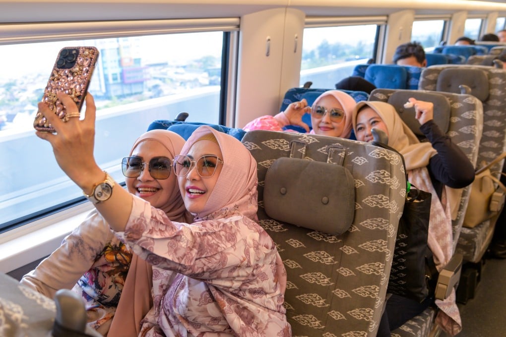 Passengers take selfies on the Jakarta-Bandung High-Speed Railway in Indonesia. Starting on Thursday, Indonesian travellers can enter China for 10 days if they have onward tickets to a third country. Photo: Xinhua
