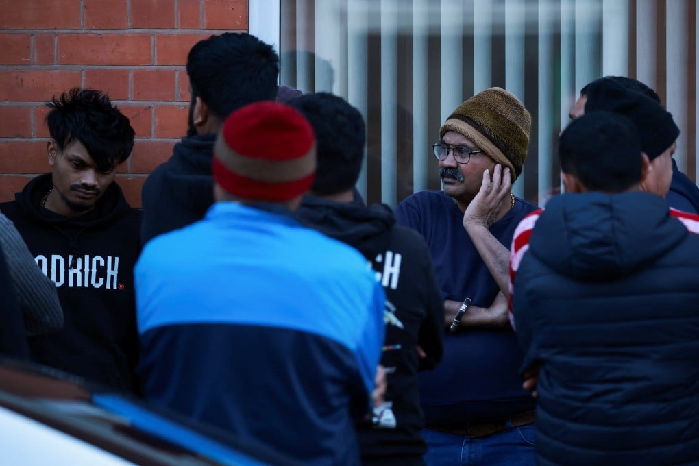 Local community members stand outside the family home of Ramesh Viswashkumar, a British survivor of the London-bound Air India aircraft crash near Ahmedabad Airport in India, in Leicester, Britain on Thursday. Photo: Reuters