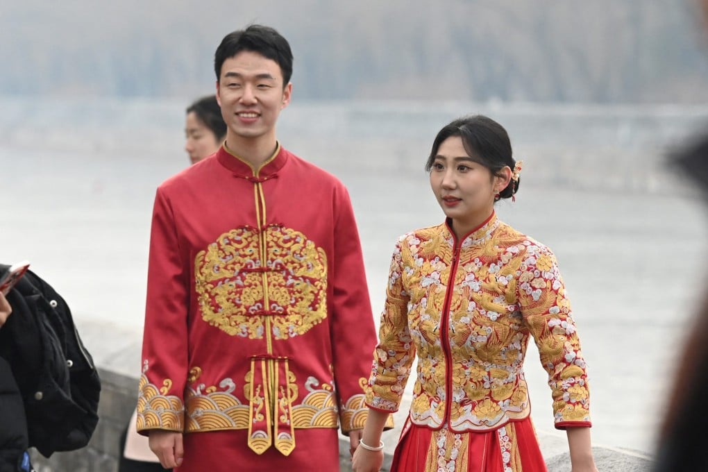 A couple waits during a wedding photo shoot outside the Forbidden City in Beijing, China, on February 11, 2025. Photo: AFP