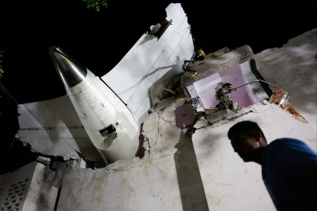 A person walks past debris at the Air India plane crash site in Ahmedabad on June 12. Photo: Reuters