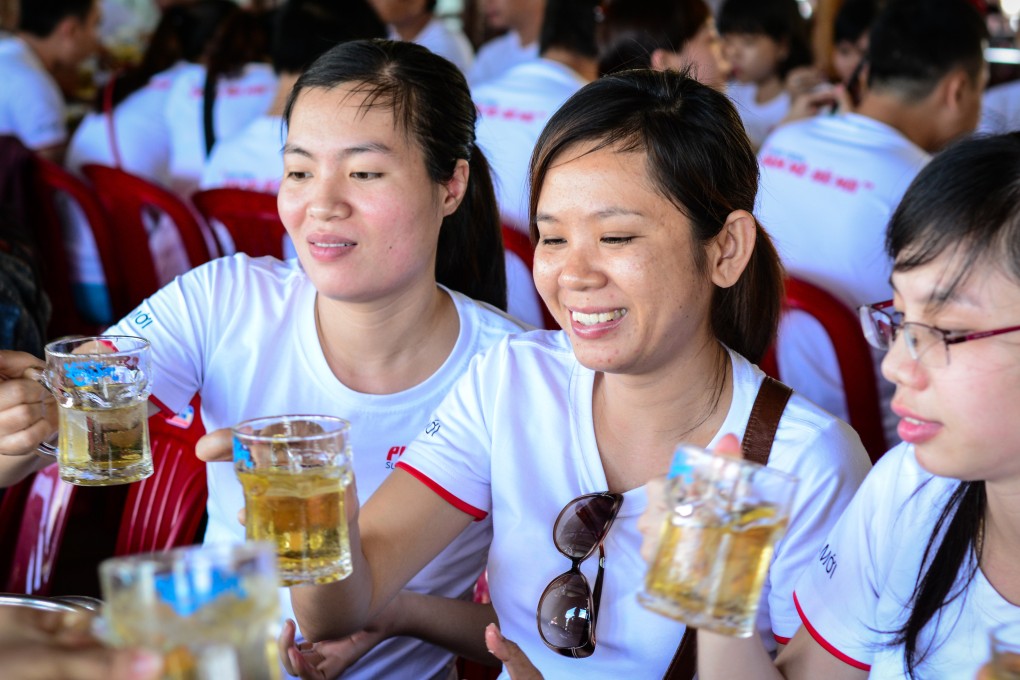 Young women drink beer at local restaurant in Saigon, Vietnam. Photo: Shutterstock