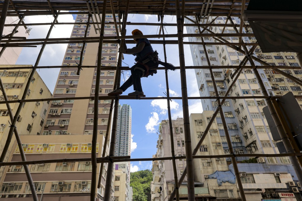 A worker erects scaffolding at a site in Shau Kei Wan. The number of private buildings aged 50 or above in Hong Kong is projected to rise from 8,700 in 2020 to about 13,900 by 2030. Photo: Jelly Tse