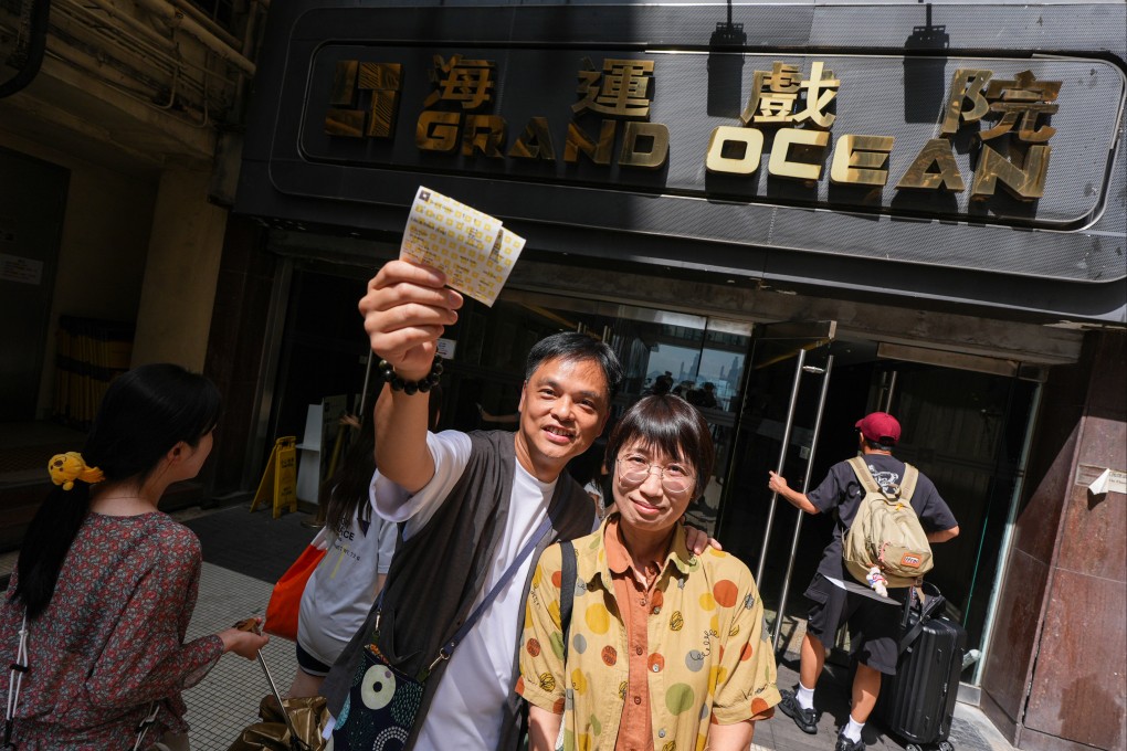 Wong Kai-Yu and his wife, Joey Chow, pose for a photo with their movie tickets outside Grand Ocean Cinema in Tsim Sha Tsui ahead of it closing after 56 years. Photo: Eugene Lee