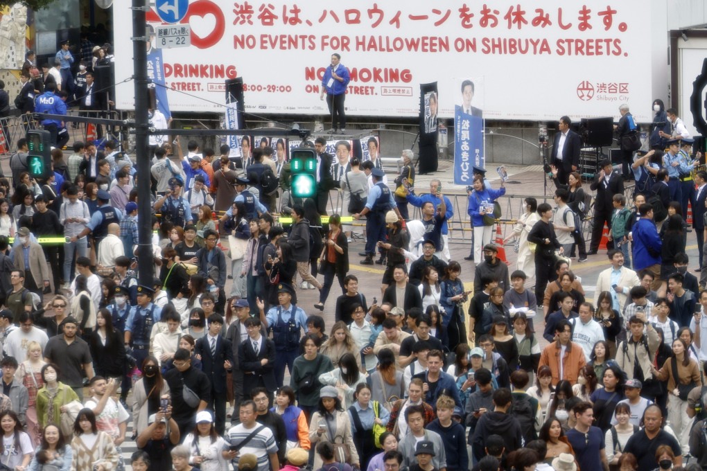 A member of the main opposition Constitutional Democratic Party of Japan delivers a stump speech at Shibuya crossing on October 26, last year. Photo: EPA-EFE
