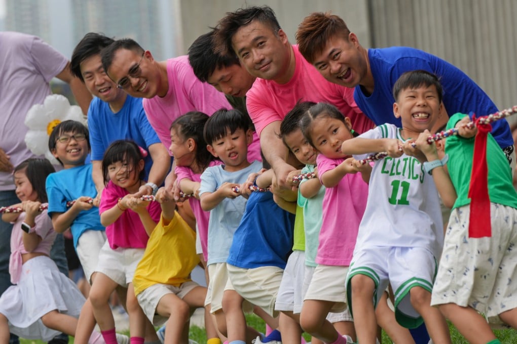 Dads join their children at a tug of war during an outing. The DADs Network has worked with more than 150 schools and reached over 10,000 fathers, children and family members across the city. Photo: May Tse