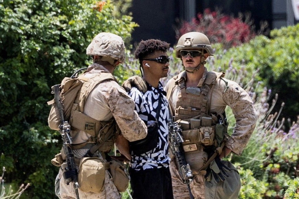 US Marines detain a man outside the Wilshire Federal Building in Los Angeles. Photo: Reuters