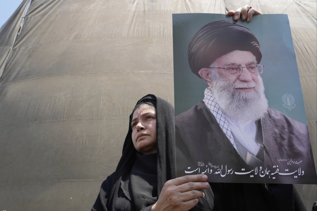 An Iranian holds up a poster of the Supreme leader Ayatollah Ali Khamenei in an anti-Israeli gathering in Tehran, Iran, on Friday. Photo: AP