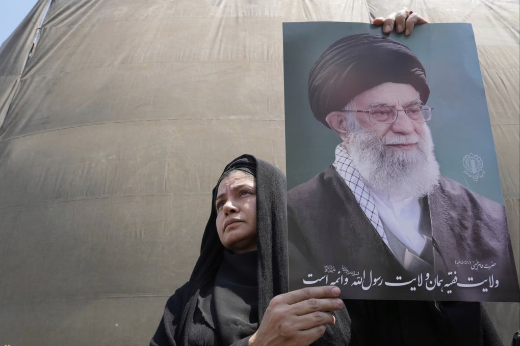 An Iranian holds up a poster of the Supreme leader Ayatollah Ali Khamenei in an anti-Israeli gathering in Tehran, Iran, on Friday. Photo: AP