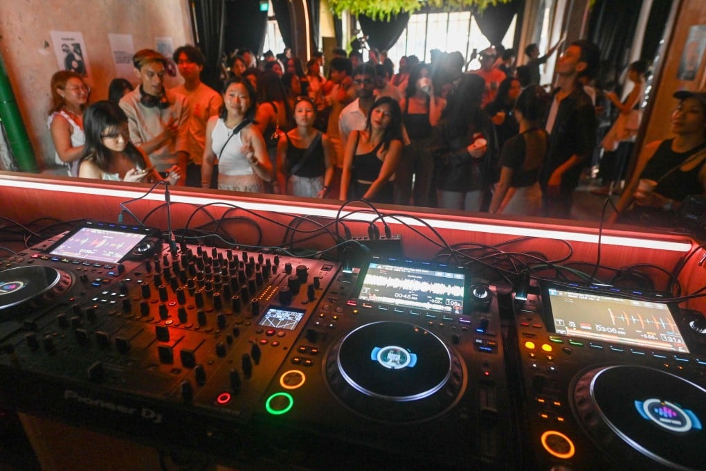 Attendees listen to music while drinking coffee at an alcohol-free clubbing event in Singapore on May 24. Photo: AFP