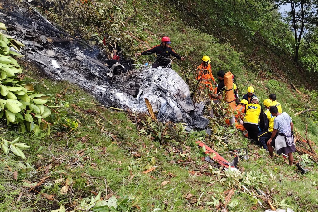 Members of rescue teams work at the site of a helicopter crash in the Gaurikund area of the northern Indian state of Uttarakhand, India, on Sunday. Photo: Reuters