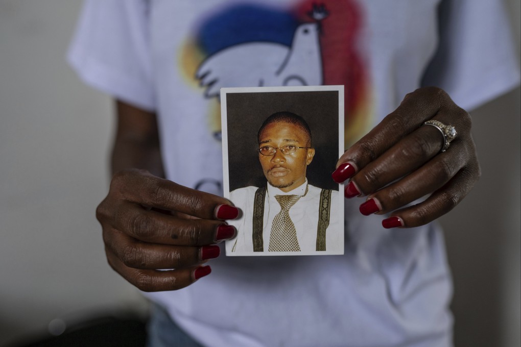 Aline Minani holds a photo of Floribert Bwana Chui Bin Kositi, a Congolese man killed in 2007 for fighting corruption, and whose beatification was approved by Pope Francis, in Goma, Democratic Republic of Congo, on December 29 last year. Photo: AP