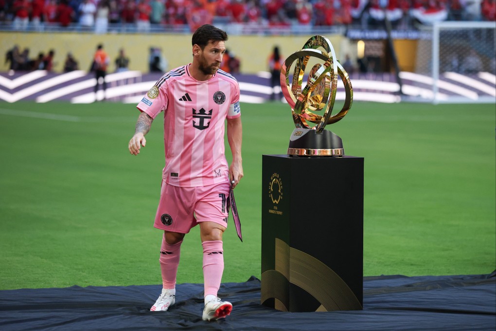 Lionel Messi passes the Club World Cup trophy before the opening match between Inter Miami and Al-Ahly in Florida. Photo: Xinhua