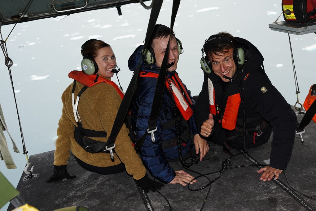 French President Emmanuel Macron, with Danish Prime Minister Mette Frederiksen and Greenlandic leader Jens-Frederik Nielsen on a helicopter tour in Greenland. Photo: Ritzau Scanpix via AP