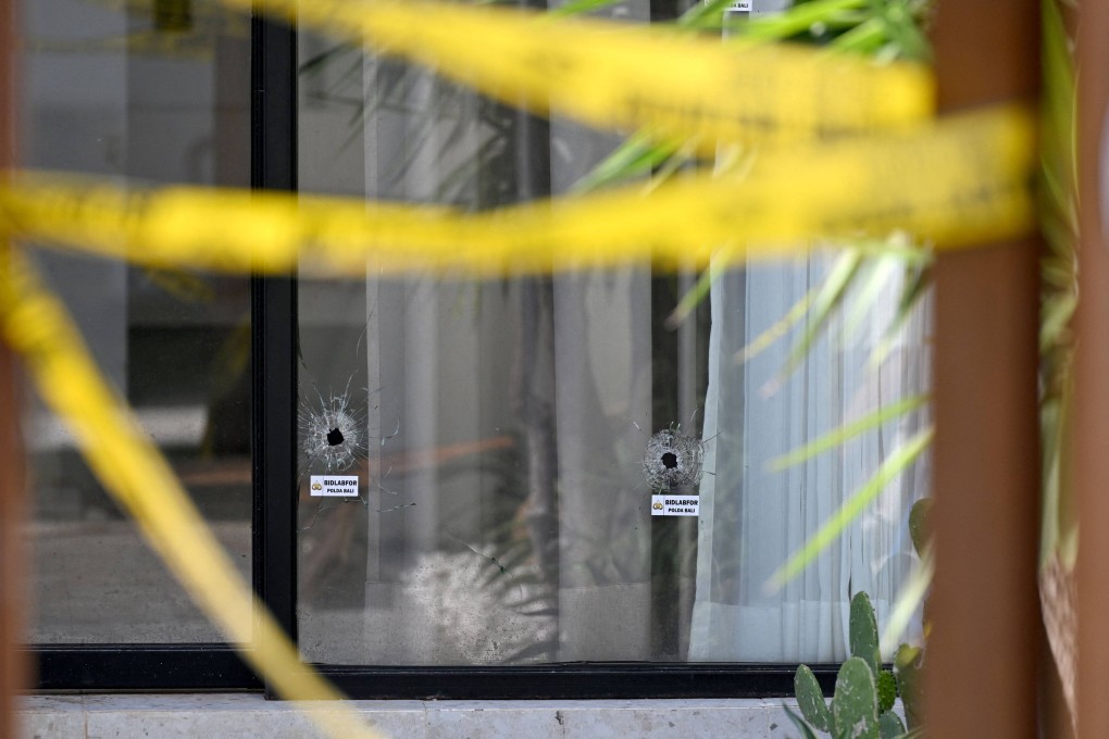 Bullet holes are seen on Sunday in the glass door of the villa in Bali where one Australian was shot dead and another wounded. Photo: AFP