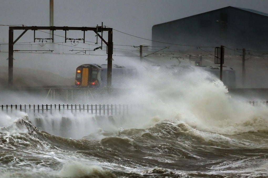 A train passes along the coast in Scotland. Many train services in Britain have been delayed or cancelled in recent years due to increasingly severe weather. File photo: EPA/EFE