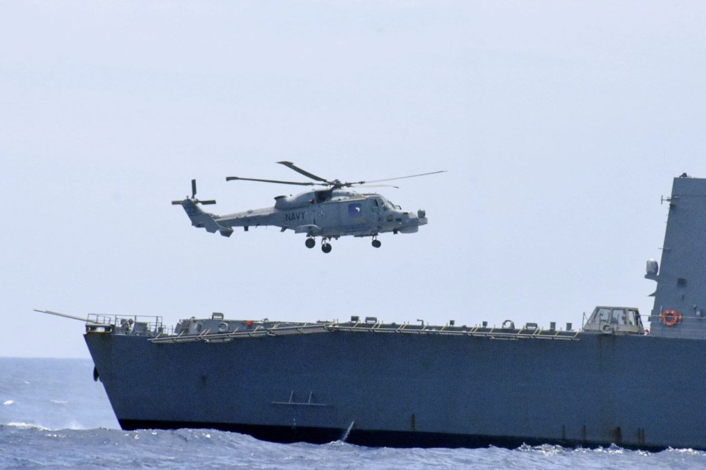 A Philippine Navy helicopter prepares to land on Japan Maritime Self-Defence Force destroyer Takanami during a joint maritime exercise held off the coast of the Philippines’ main island of Luzon in the South China Sea on June 14. Photo: Kyodo