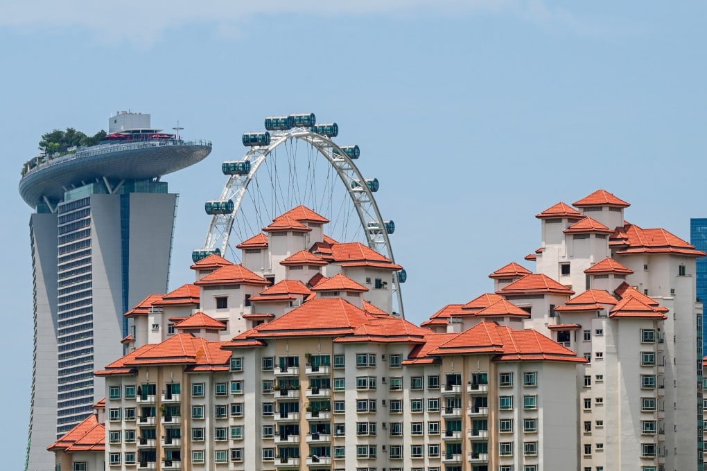 Private apartments are seen against the backdrop of the Marina Bay Sands hotel and the Singapore Flyer observatory wheel in Singapore. Photo: AFP