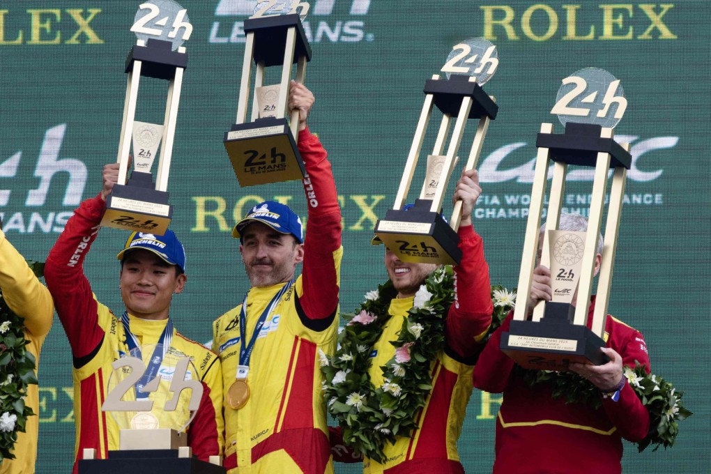 AF Corse drivers (from left) Ye Yifei, Robert Kubica and Philip Hanson lift their trophies at the Le Mans circuit on Sunday. Photo: AFP