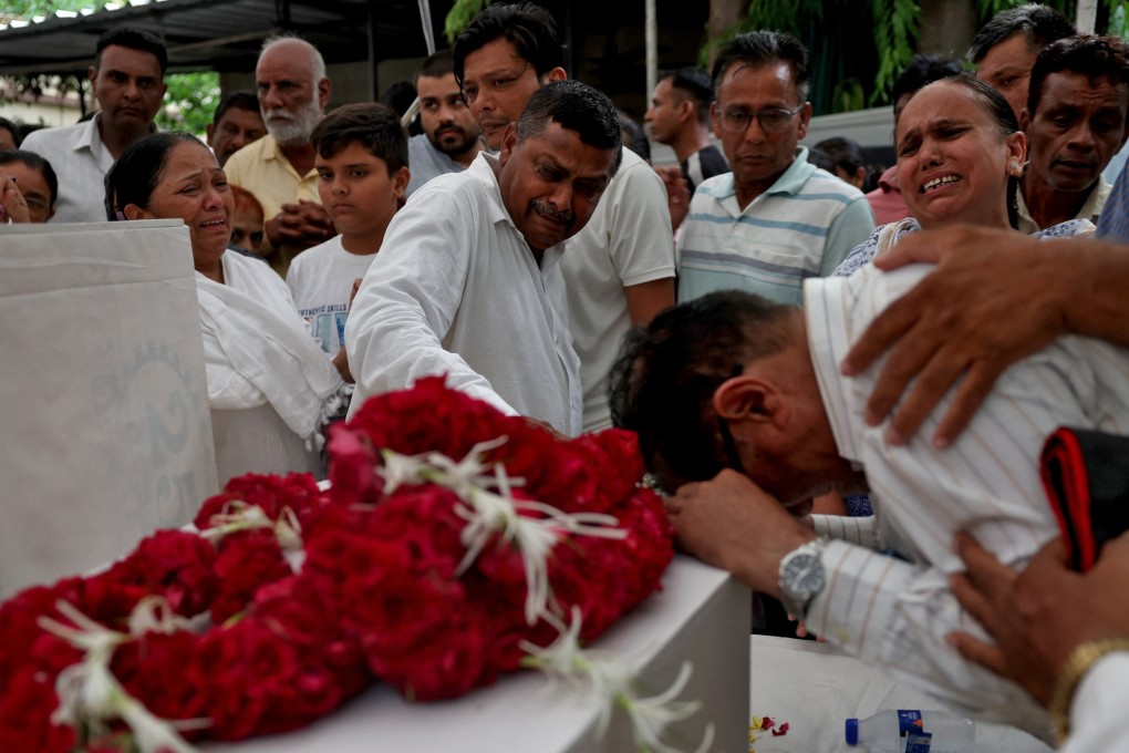 Relatives in Ahmedabad on Sunday react next to the coffins of passengers who lost their lives in the Air India plane crash. Photo: Reuters