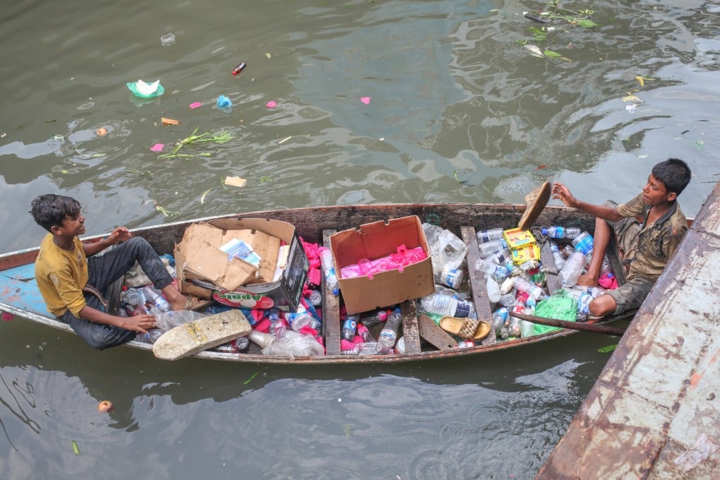 Child labourers collect plastic waste from the Buriganga River in Dhaka, Bangladesh, on June 5. Photo: EPA-EFE