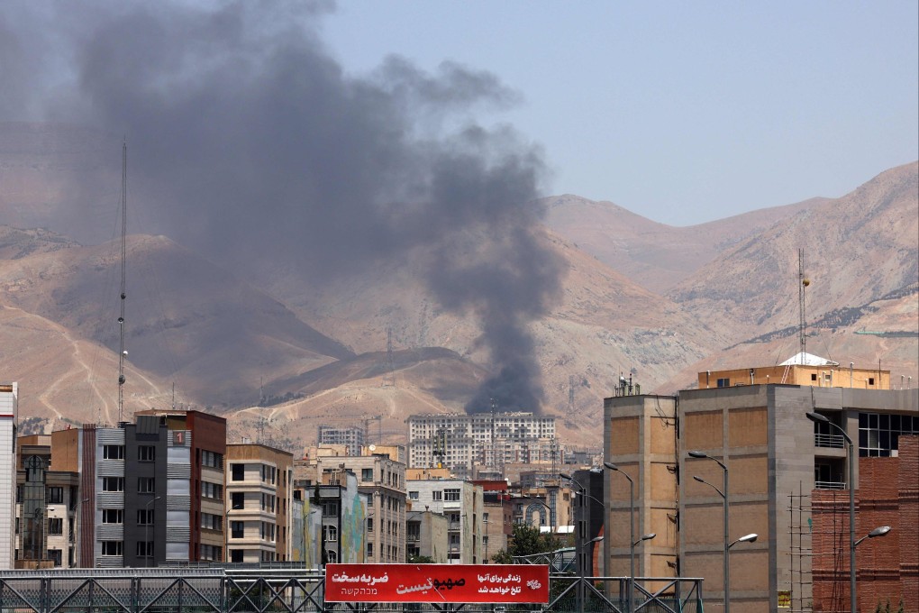 Smoke billows from an oil depot northwest of Iran’s capital Tehran on Monday. The nation has unleashed a barrage of missile strikes on Israel after it struck targets deep inside Iran, with both sides threatening further devastation. Photo: AFP