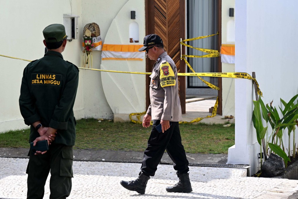 A police officer walks past the villa in Bali where one Australian was shot dead and another wounded at the weekend. Photo: AFP