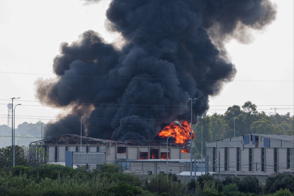 Smoke billows from a fire in a building in Herzliya near Tel Aviv following a fresh barrage of Iranian rockets on Tuesday. Photo: AFP