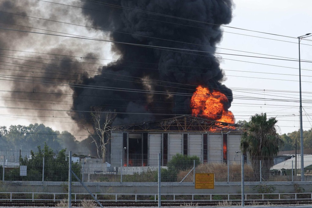Smoke billows from a building in Israel’s Herzliya near Tel Aviv following a fresh barrage of Iranian rockets on Tuesday. Photo: AFP