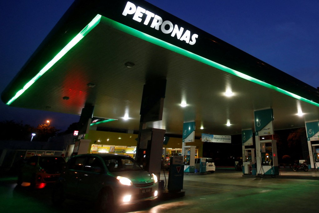 A motorist pumps petrol at a Petronas gas station in Putrajaya. Malaysia is planning to go ahead with petrol subsidy cuts as early as July. Photo: Reuters
