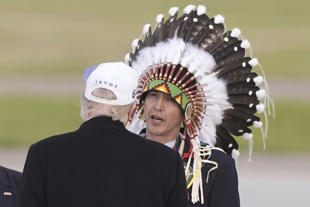 US President Donald Trump being greeted by Steven Crowchild in Calgary, Canada. Photo: AP