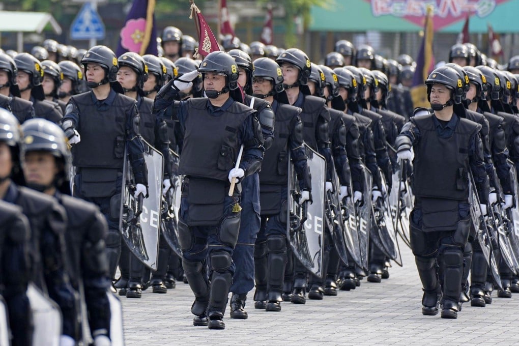 Members of the Tokyo Metropolitan Police Department’s riot squad march during an inspection ceremony in the Japanese capital last month. Photo: Kyodo
