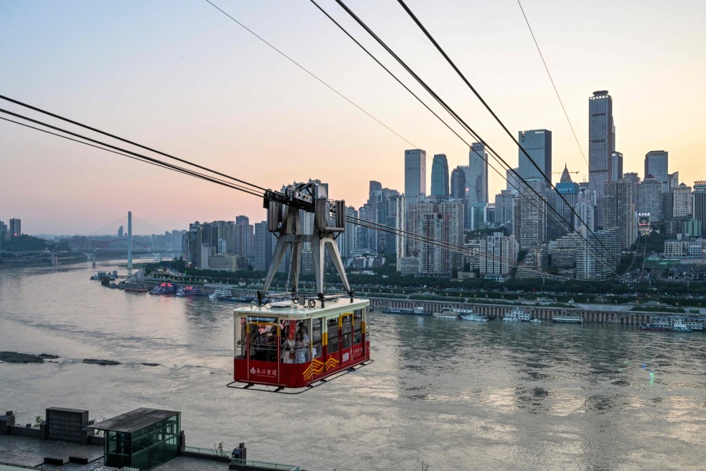 People ride a cable car over the Yangtze River in Chongqing, southwestern China on June 11. Photo: AFP