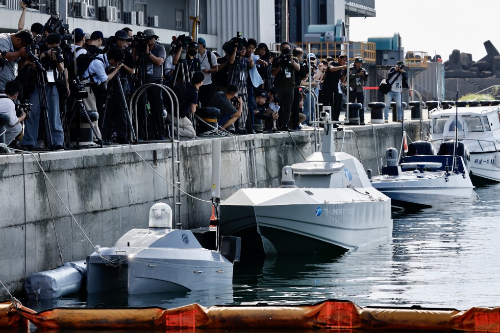 Journalists film the uncrewed surface vehicles ahead of demonstrations showcasing newly developed water surface drones, at Suao port in Yilan, Taiwan, on Tuesday. Photo: EPA-EFe