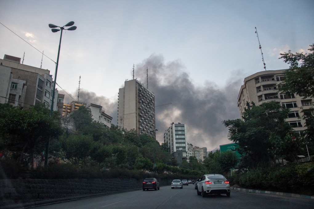 Smoke rises from the rubble of an Iranian state media building in Tehran on June 16. Photo: AFP/Getty Images/TNS