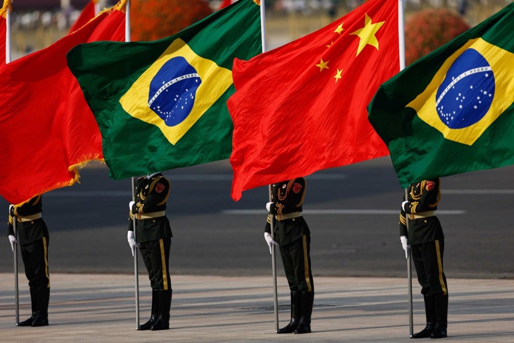 Honour guard members hold national flags of China and Brazil before a welcome ceremony for Brazil’s President Luiz Inacio Lula da Silva in Beijing on May 13. Photo: AFP