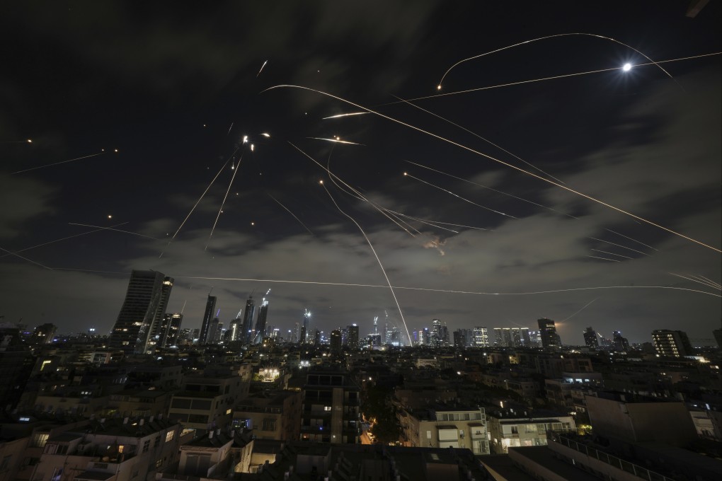 The Israeli Iron Dome air defence system fires to intercept missiles over Tel Aviv on Sunday. Photo: AP