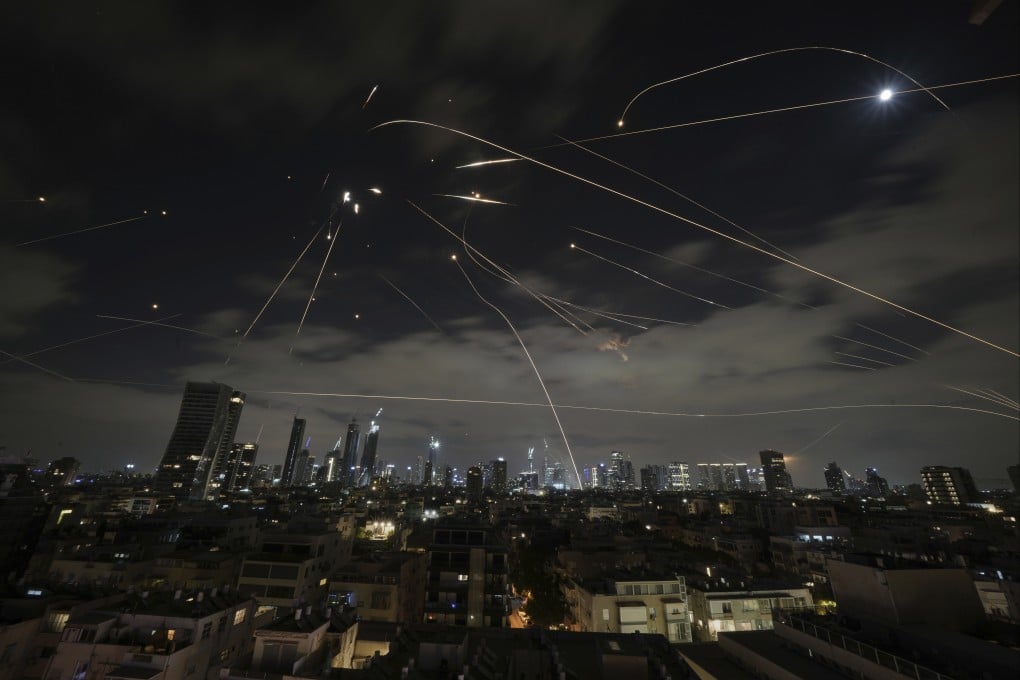 The Israeli Iron Dome air defence system fires to intercept missiles over Tel Aviv on Sunday. Photo: AP