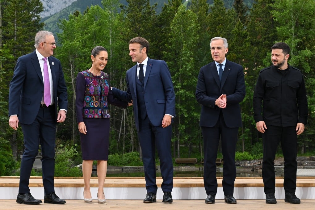 (From left) Australian Prime Minister Anthony Albanese, Mexican President Claudia Sheinbaum, French President Emmanuel Macron, Canadian Prime Minister Mark Carney and Ukrainian President Volodymyr Zelenskiy pose for a photo during the G7 summit in Kananaskis, Alberta, Canada, on Tuesday. Photo: AAP/dpa