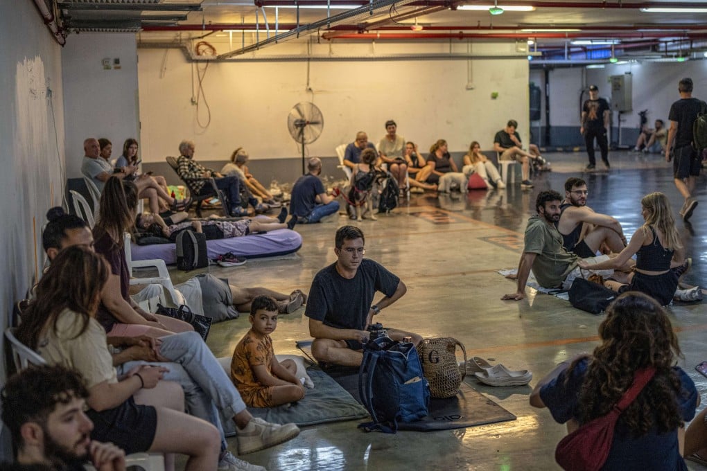 Israelis take shelter in an underground station as they anticipate another missile attack by Iran on Tuesday. Photo: dpa
