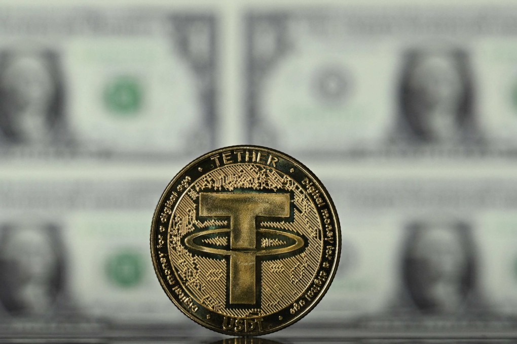 An illustration picture taken on May 8, 2022, shows a cryptocurrency Tether (USDT) coin arranged in front of a screen displaying US dollar notes. Photo: AFP
