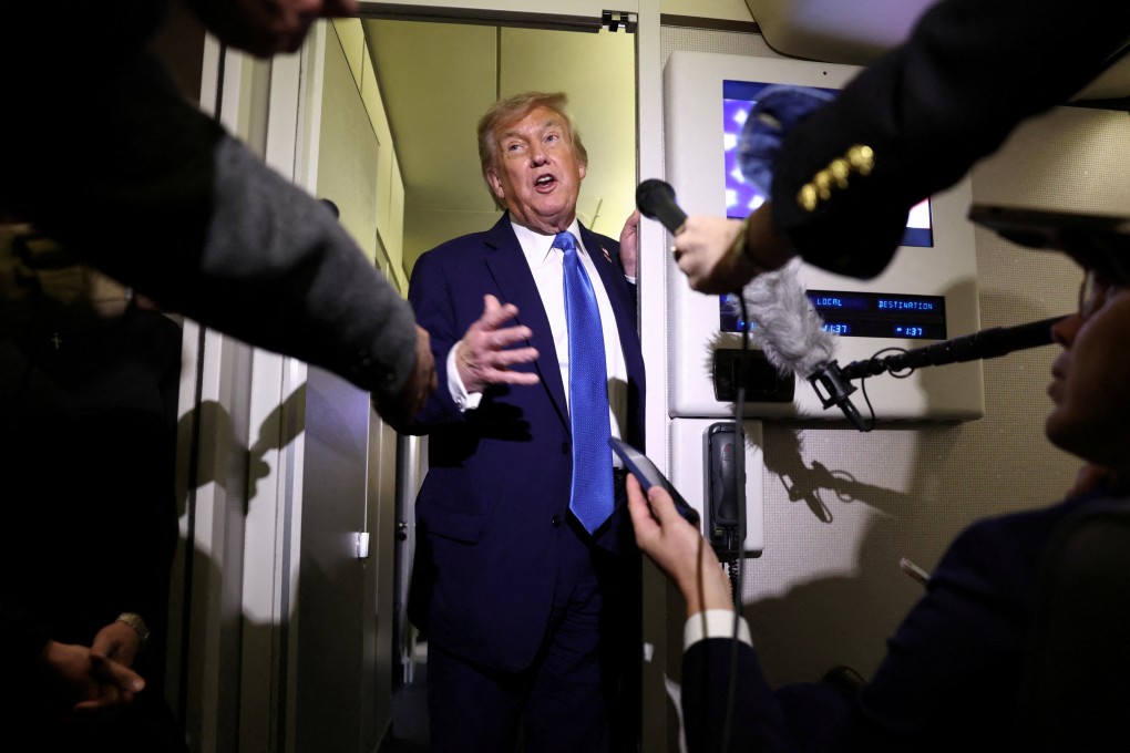 US President Donald Trump speaks to reporters aboard Air Force One after departing early from the the G7 summit in Canada to return to Washington. Photo: Reuters