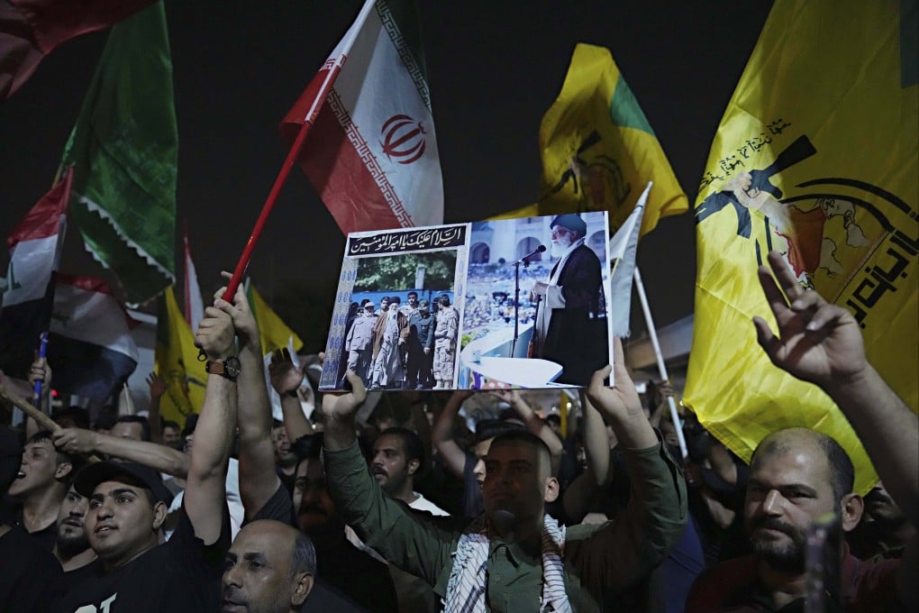 A protester in Baghdad, Iraq holds a portrait of Iran’s Supreme Leader Ayatollah Ali Khamenei during a Wednesday protest against Israeli attacks on multiple cities across Iran. Photo: AP