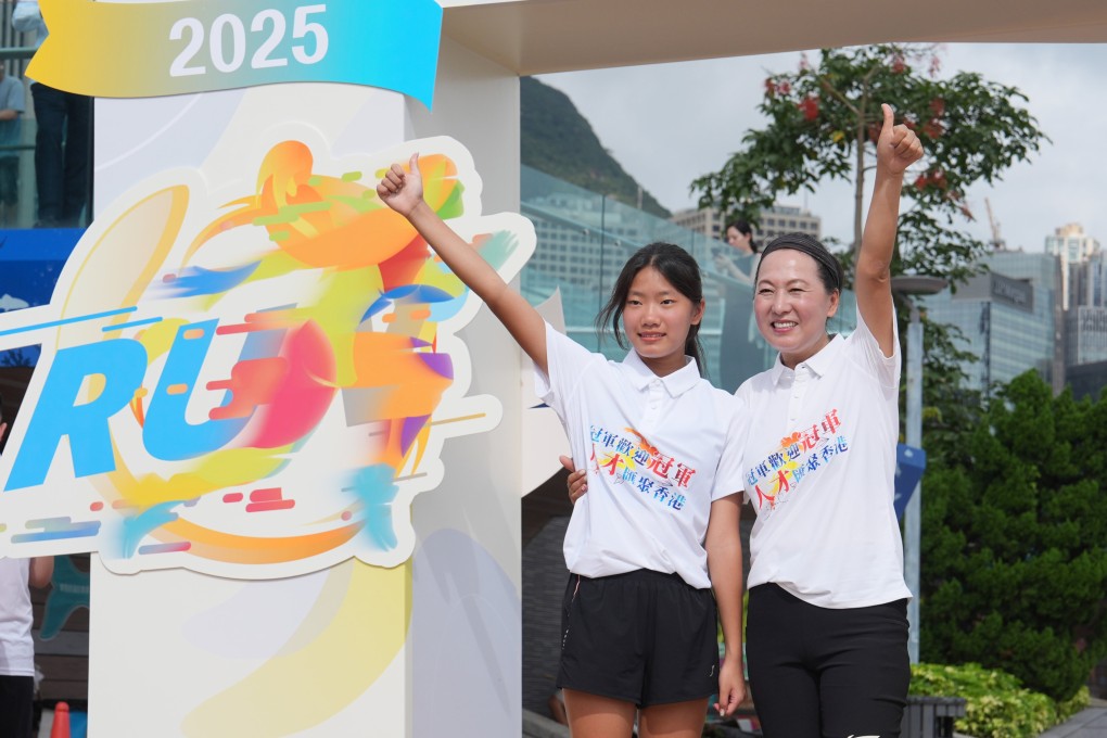 Wang Junxia (right) and daughter Wang Danting pose for pictures before a morning jogging session arranged by the Hong Kong Talent Exchange and Jockey Club. Photo: Elson Li