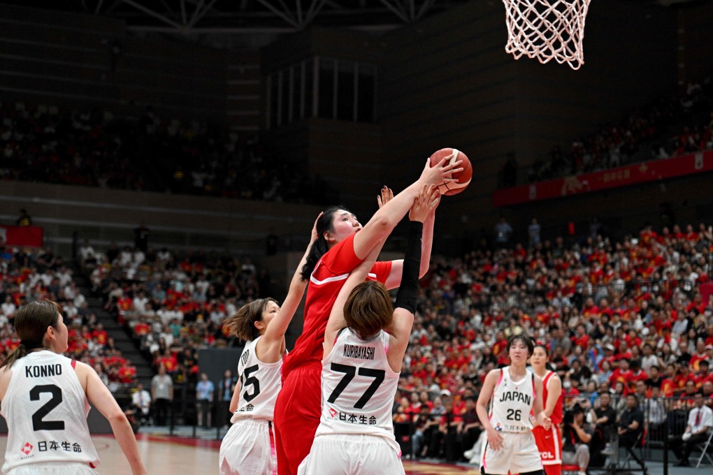 China’s Zhang Ziyu (in red) shoots as Japan’s Miwa Kuribayashi (77) and Nanako Todo (75) try to block during their warm-up game on Wednesday. Photo: AFP